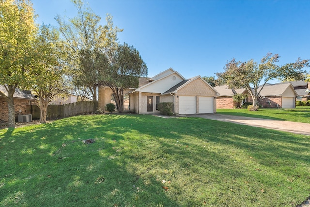 view of front of property featuring cooling unit, a garage, and a front lawn