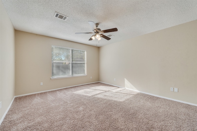 carpeted spare room with ceiling fan and a textured ceiling