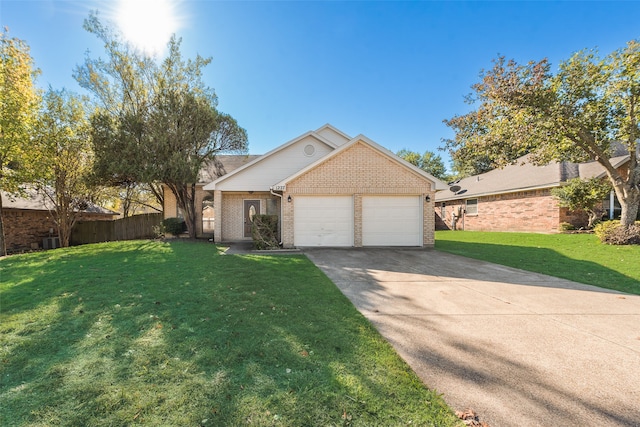 view of front of property featuring a garage and a front lawn