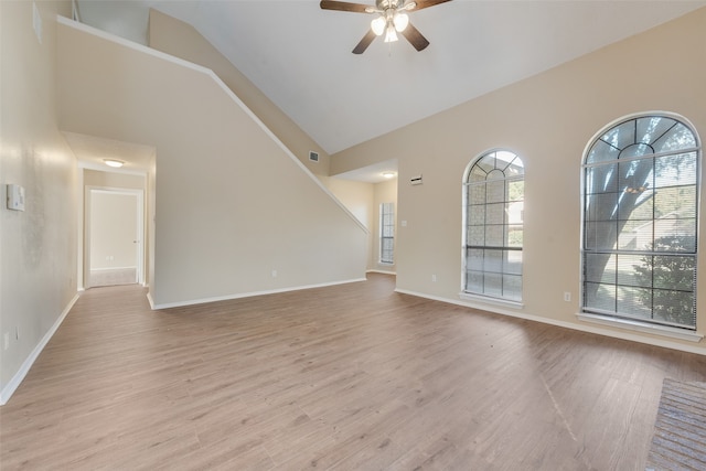 interior space with ceiling fan, high vaulted ceiling, and light wood-type flooring