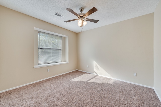 carpeted spare room with ceiling fan and a textured ceiling