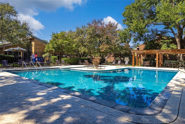 view of swimming pool with a patio area and a pergola