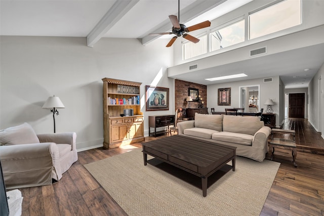 living room featuring beamed ceiling, dark hardwood / wood-style floors, high vaulted ceiling, and ceiling fan