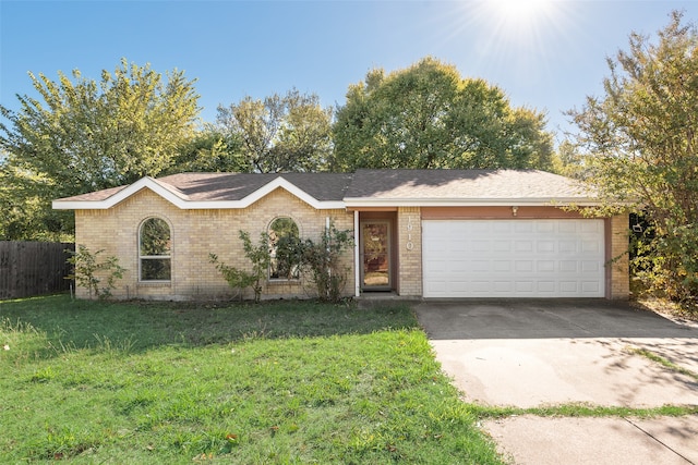 ranch-style home featuring a front yard and a garage