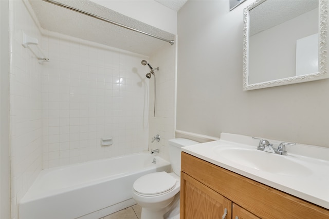 full bathroom with vanity, tile patterned flooring, tiled shower / bath combo, toilet, and a textured ceiling