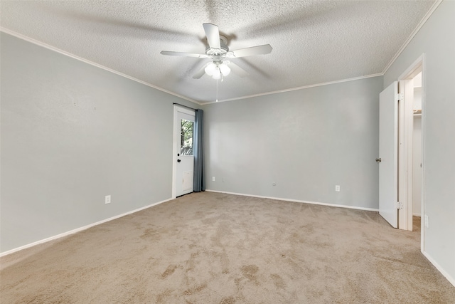 spare room with light carpet, a textured ceiling, ceiling fan, and ornamental molding