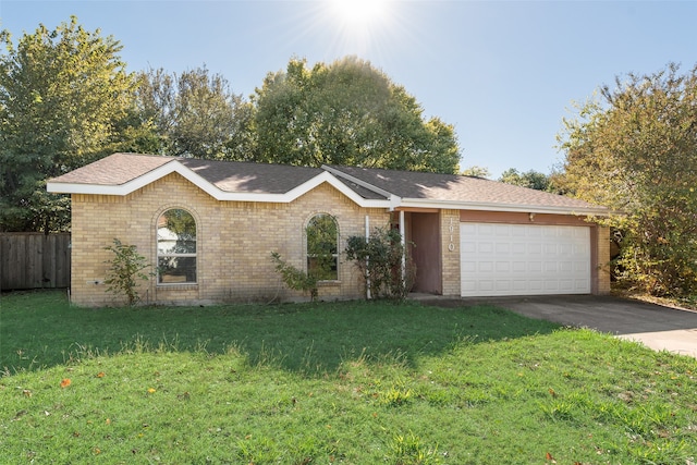 ranch-style home featuring a garage and a front yard