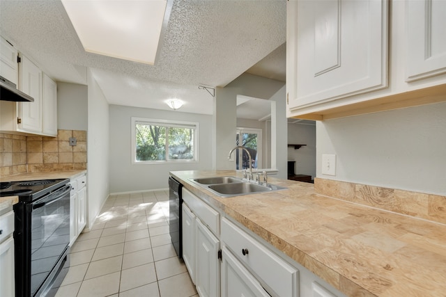 kitchen featuring white cabinetry, sink, backsplash, a textured ceiling, and black appliances