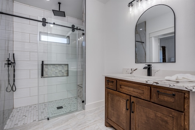 bathroom featuring vanity and a shower with door