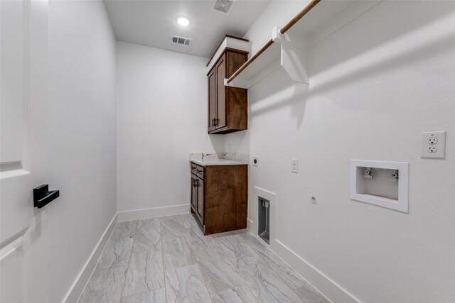 laundry area featuring hookup for an electric dryer, hookup for a gas dryer, cabinets, and washer hookup