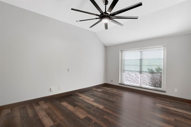 empty room with dark hardwood / wood-style floors, ceiling fan, and vaulted ceiling