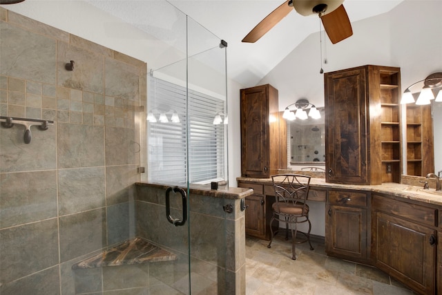 bathroom with vanity, ceiling fan, lofted ceiling, and a shower with shower door