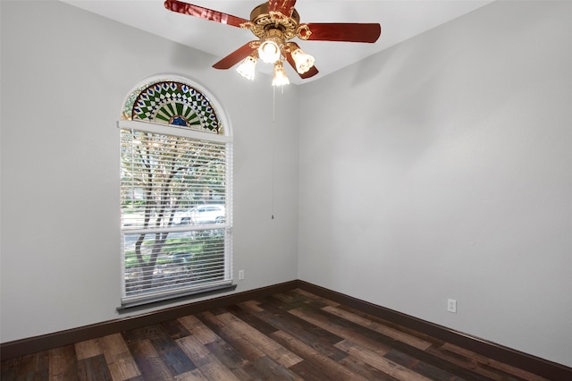 spare room featuring dark hardwood / wood-style flooring and ceiling fan