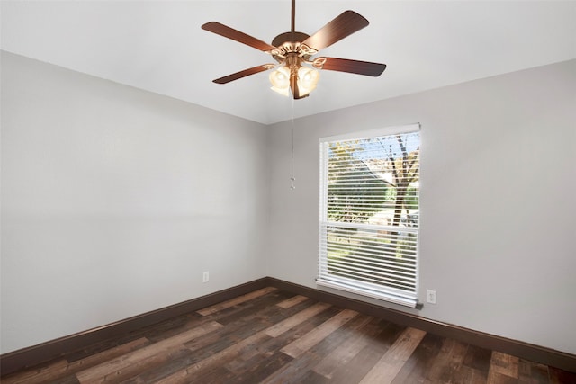 spare room with dark hardwood / wood-style floors and ceiling fan