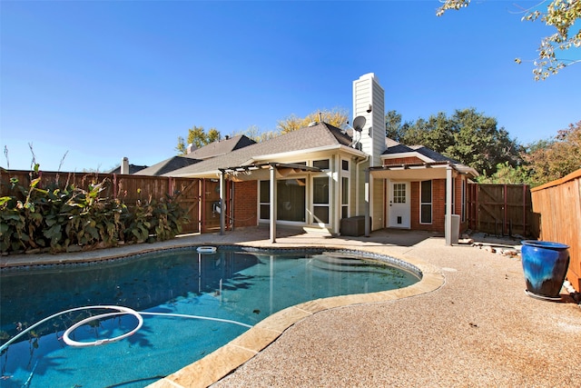 view of swimming pool with a patio