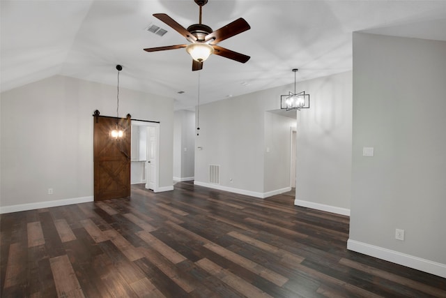 unfurnished living room featuring ceiling fan, a barn door, dark hardwood / wood-style flooring, and lofted ceiling