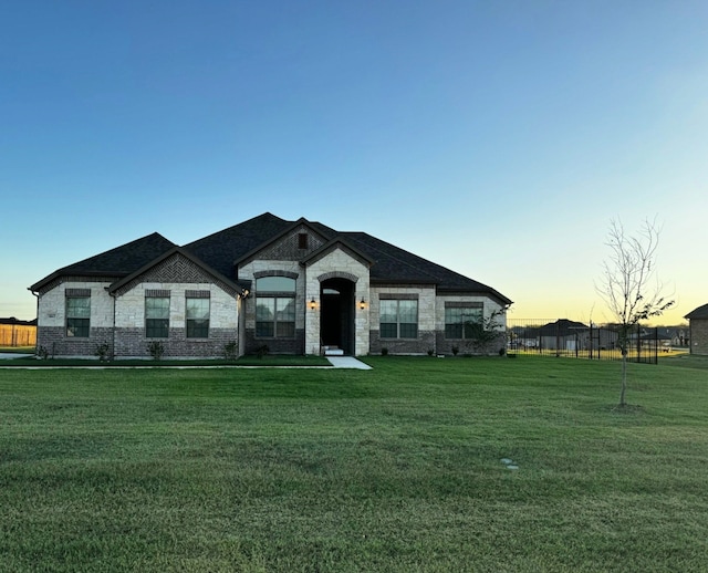 french provincial home featuring a lawn