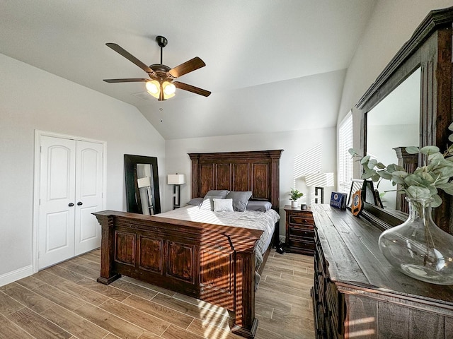 bedroom with lofted ceiling, ceiling fan, and light wood-type flooring