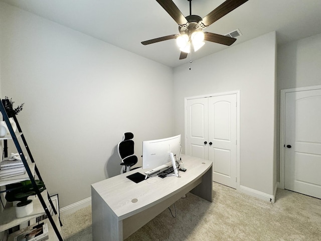 carpeted office space featuring ceiling fan