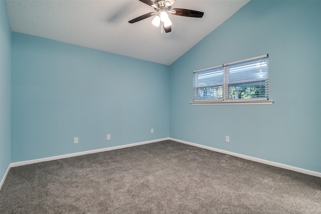 empty room featuring a textured ceiling, ceiling fan, carpet floors, and vaulted ceiling