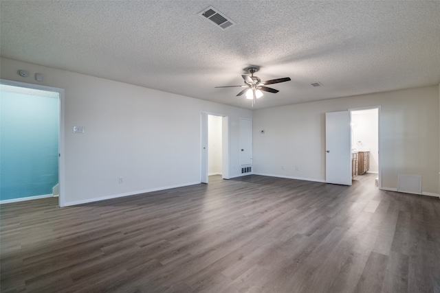 unfurnished room featuring ceiling fan, dark hardwood / wood-style flooring, and a textured ceiling