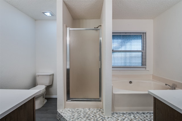 full bathroom featuring a textured ceiling, vanity, separate shower and tub, hardwood / wood-style flooring, and toilet