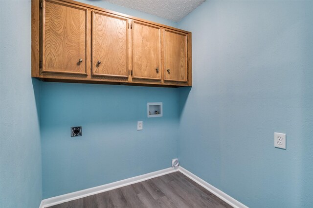 washroom with cabinets, washer hookup, a textured ceiling, electric dryer hookup, and dark hardwood / wood-style floors