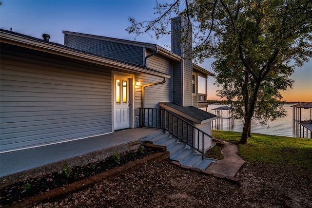 view of exterior entry at dusk