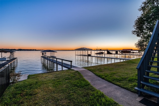 view of dock featuring a yard and a water view