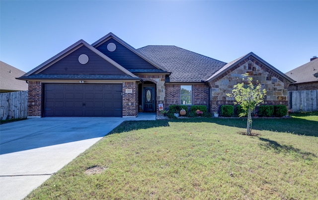 view of front of home with a front yard and a garage