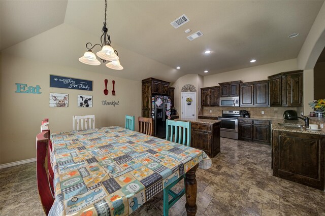 dining room with lofted ceiling and sink