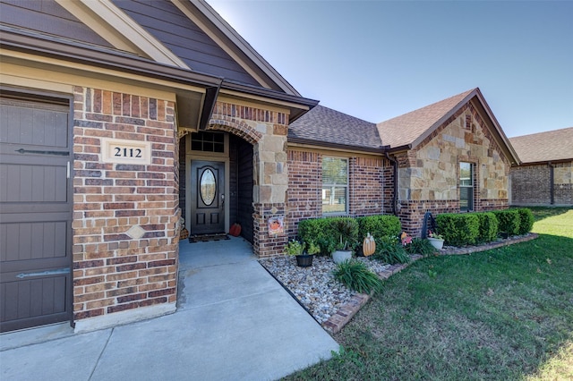 entrance to property with a yard and a garage