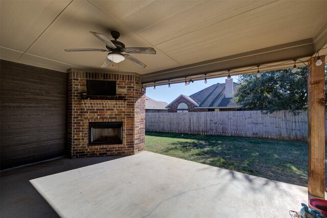 view of patio / terrace featuring ceiling fan and an outdoor brick fireplace