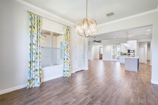 interior space with sink, ceiling fan with notable chandelier, and ornamental molding