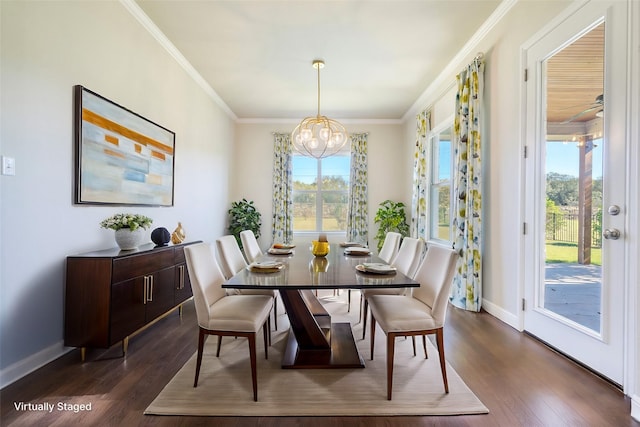 dining space featuring crown molding, dark wood-type flooring, and a notable chandelier