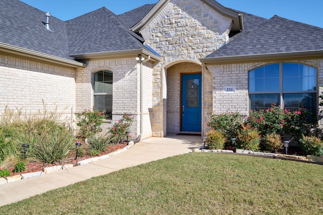 entrance to property with a lawn