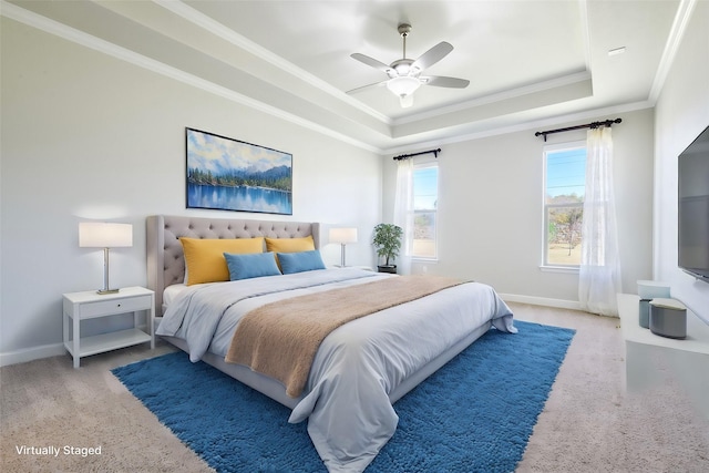 bedroom featuring a tray ceiling, ceiling fan, carpet floors, and ornamental molding