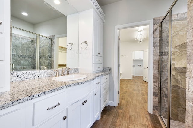 bathroom featuring vanity and a shower with shower door