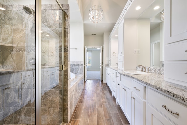 bathroom with vanity and separate shower and tub