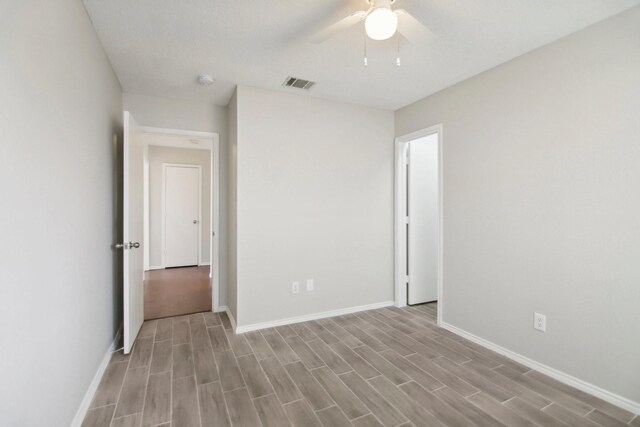 unfurnished room with ceiling fan and light hardwood / wood-style flooring