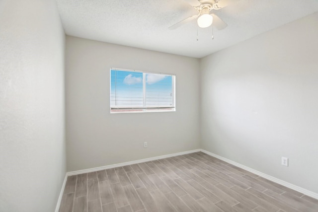 unfurnished room with a textured ceiling, light hardwood / wood-style floors, and ceiling fan