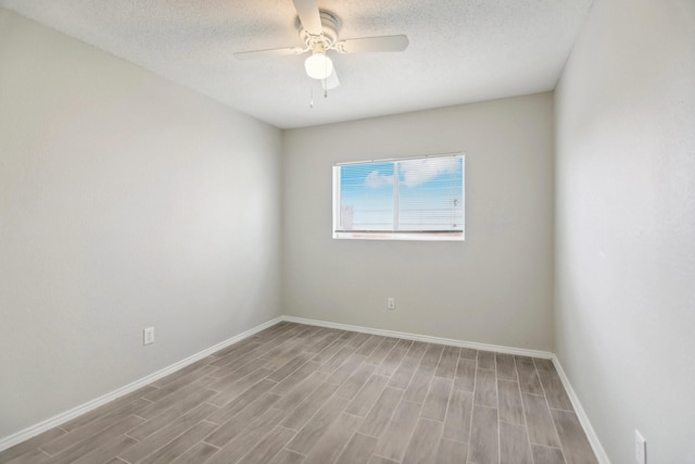 unfurnished room with ceiling fan, light hardwood / wood-style flooring, and a textured ceiling