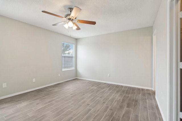 empty room featuring ceiling fan, light hardwood / wood-style floors, and a textured ceiling