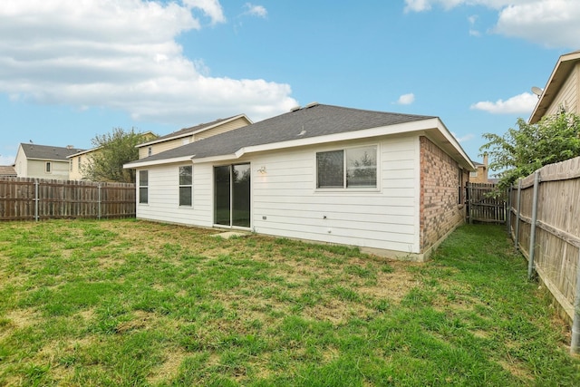 back of house featuring a yard