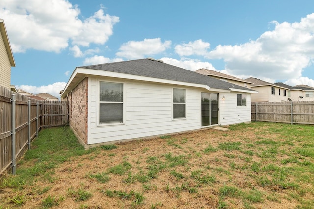 back of house featuring a yard