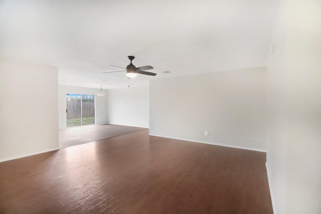 empty room featuring dark hardwood / wood-style flooring and ceiling fan