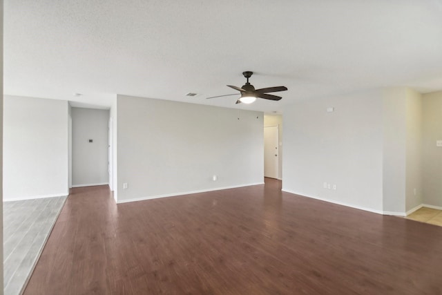 spare room featuring ceiling fan, dark hardwood / wood-style flooring, and a textured ceiling