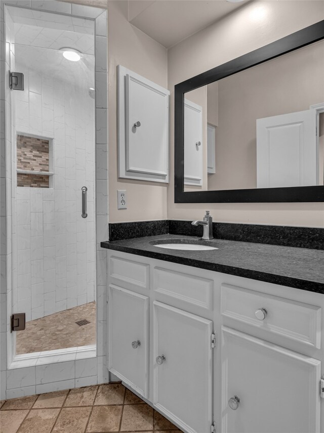 bathroom featuring vanity and a shower with shower door