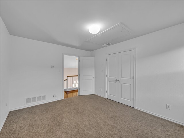 unfurnished bedroom featuring carpet floors and a closet