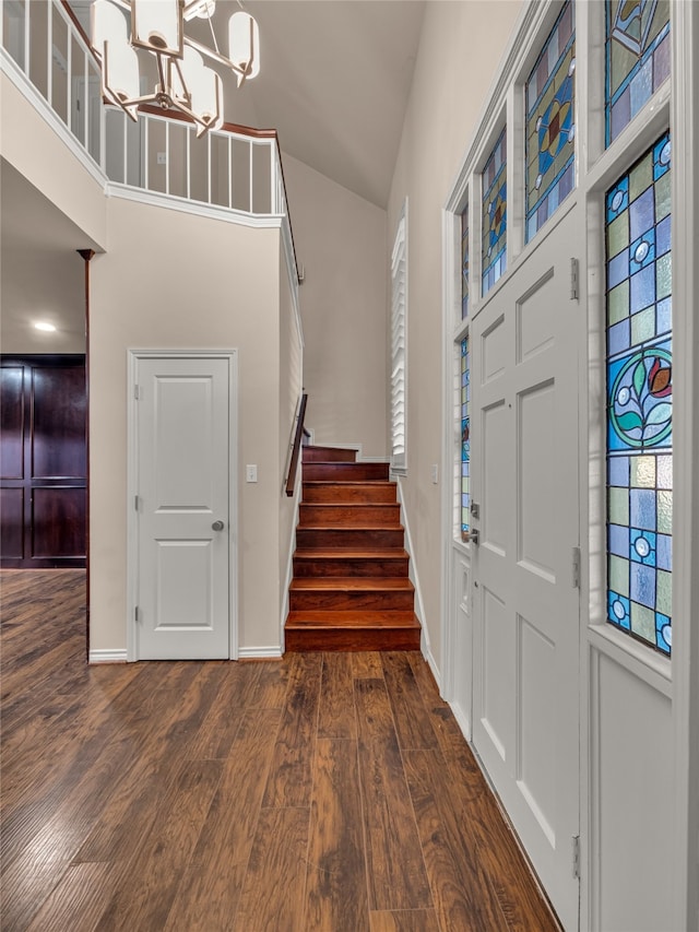 entryway featuring high vaulted ceiling, a chandelier, and dark hardwood / wood-style floors